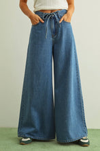 Load image into Gallery viewer, Person wearing wide-leg blue jeans against a plain background