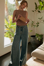 Load image into Gallery viewer, Woman holding a piece of paper in a room with plants