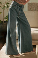 Load image into Gallery viewer, Person wearing wide-leg jeans in a living room setting