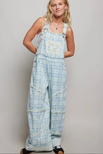 Load image into Gallery viewer, Woman wearing a checkered overalls with a plain background