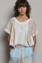 Load image into Gallery viewer, Woman wearing a floral top and light blue pants against a plain background