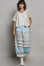 Load image into Gallery viewer, Woman wearing a layered outfit with a floral kimono-style top and light blue skirt on a gray background