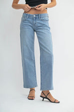 Load image into Gallery viewer, Person wearing light blue jeans on a white background