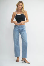 Load image into Gallery viewer, Woman wearing a black tank top and light blue jeans on a white background