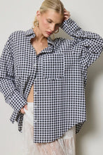 Load image into Gallery viewer, Woman wearing a black and white checkered shirt against a plain background