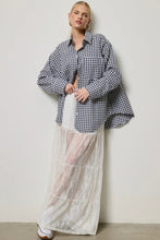 Load image into Gallery viewer, Person wearing a black and white checkered shirt over a sheer white dress against a plain background
