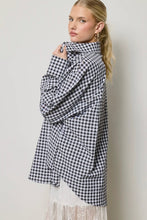 Load image into Gallery viewer, Woman wearing a black and white checkered coat against a plain background