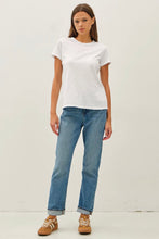 Load image into Gallery viewer, Woman wearing a white t-shirt and blue jeans on a plain background
