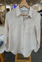 Load image into Gallery viewer, White and gray striped shirt on a wooden hanger with a blurred store background