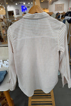 Load image into Gallery viewer, Striped shirt on a wooden hanger with a store interior background