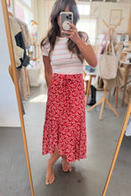 Load image into Gallery viewer, Woman taking a mirror selfie wearing a striped shirt and red floral skirt in a store.