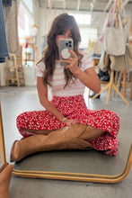 Load image into Gallery viewer, Person taking a mirror selfie wearing a striped shirt, red floral skirt, and brown boots in a clothing store.