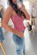 Load image into Gallery viewer, Person wearing a red checkered top and blue jeans in a store setting.