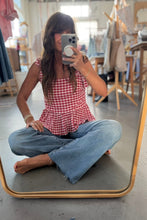 Load image into Gallery viewer, Person taking a mirror selfie wearing a red checkered top and blue jeans in an indoor setting.