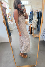 Load image into Gallery viewer, Woman taking a mirror selfie wearing a floral dress in a clothing store.