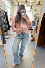 Load image into Gallery viewer, Person taking a mirror selfie wearing a striped shirt and jeans in a clothing store.