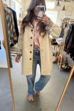 Load image into Gallery viewer, Person wearing a beige coat in a clothing store