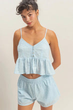 Load image into Gallery viewer, Woman wearing a light blue top and shorts set against a plain background
