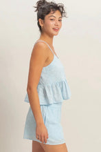 Load image into Gallery viewer, Woman wearing a light blue tiered romper against a plain background