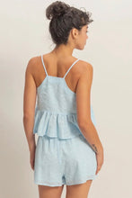 Load image into Gallery viewer, Woman wearing a light blue romper against a plain background