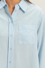 Load image into Gallery viewer, Light blue button-up shirt with a pocket on a neutral background