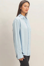 Load image into Gallery viewer, Woman wearing a light blue shirt against a plain background