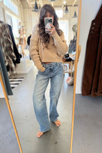 Load image into Gallery viewer, Person taking a mirror selfie wearing a beige sweater and light blue jeans in a store.