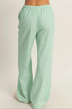 Load image into Gallery viewer, Green striped pants on a plain background