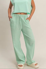 Load image into Gallery viewer, Person wearing a light green top and matching pants on a plain background