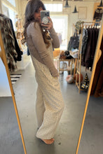 Load image into Gallery viewer, Person taking a mirror selfie wearing a brown long-sleeve top and plaid pants in a clothing store.