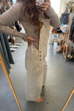 Load image into Gallery viewer, Person wearing a checkered dress in a clothing store.