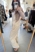 Load image into Gallery viewer, Person wearing a checkered dress in a clothing store.