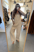 Load image into Gallery viewer, Person wearing a checkered outfit in a store setting