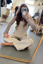 Load image into Gallery viewer, Person wearing a checkered outfit sitting on a mat in a store.