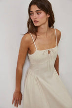 Load image into Gallery viewer, Woman wearing a beige dress with thin straps against a plain background