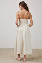 Load image into Gallery viewer, Woman wearing a white dress with thin straps against a plain background