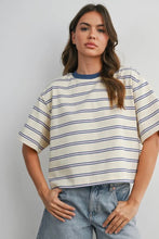 Load image into Gallery viewer, Woman wearing a striped shirt and jeans against a plain background