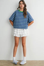 Load image into Gallery viewer, Woman wearing a blue striped shirt and white ruffled skirt against a plain background