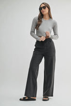 Load image into Gallery viewer, Woman wearing a gray long-sleeve top and dark pants on a white background