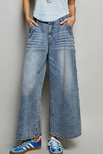 Load image into Gallery viewer, Person wearing wide-leg jeans and blue sneakers against a plain background