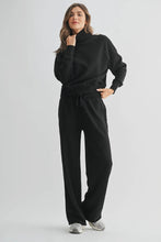 Load image into Gallery viewer, Woman wearing a black outfit on a white background