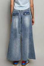 Load image into Gallery viewer, Person wearing wide-leg blue jeans on a plain background