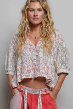 Load image into Gallery viewer, Woman wearing a floral blouse and red pants against a plain background