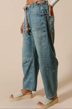 Load image into Gallery viewer, Person wearing blue jeans with a beige background