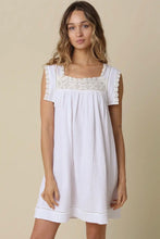 Load image into Gallery viewer, Woman wearing a white dress with lace details on a beige background