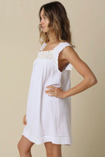 Load image into Gallery viewer, Woman wearing a white dress with lace details on a beige background