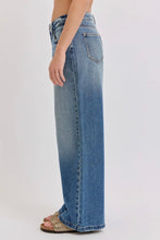 Load image into Gallery viewer, Blue jeans worn by a person on a white background
