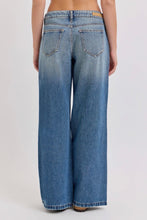 Load image into Gallery viewer, Person wearing blue wide-leg jeans on a plain background