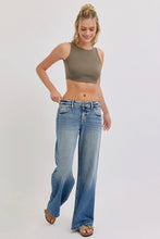 Load image into Gallery viewer, Woman wearing a green crop top and blue jeans on a white background