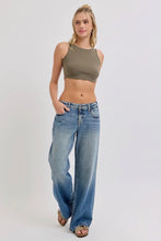 Load image into Gallery viewer, Woman wearing a green crop top and blue jeans on a white background